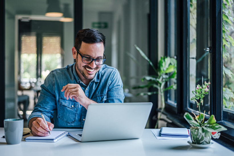 Man smiling at laptop