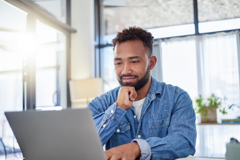 Man smiling at laptop