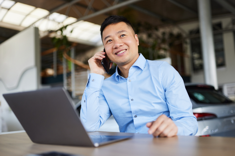 Man at dealership on phone